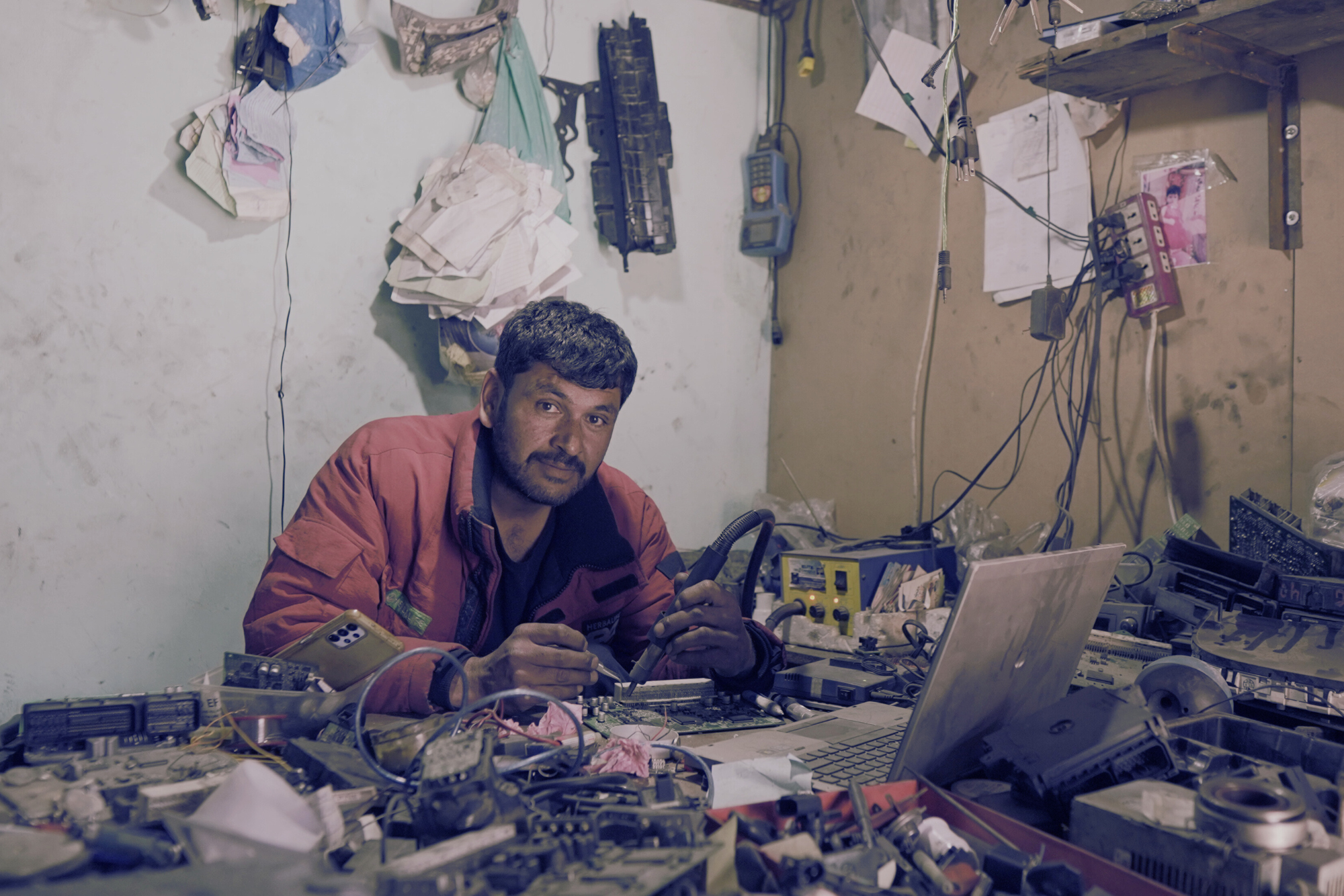 mechanic working on a car electronic in workshop