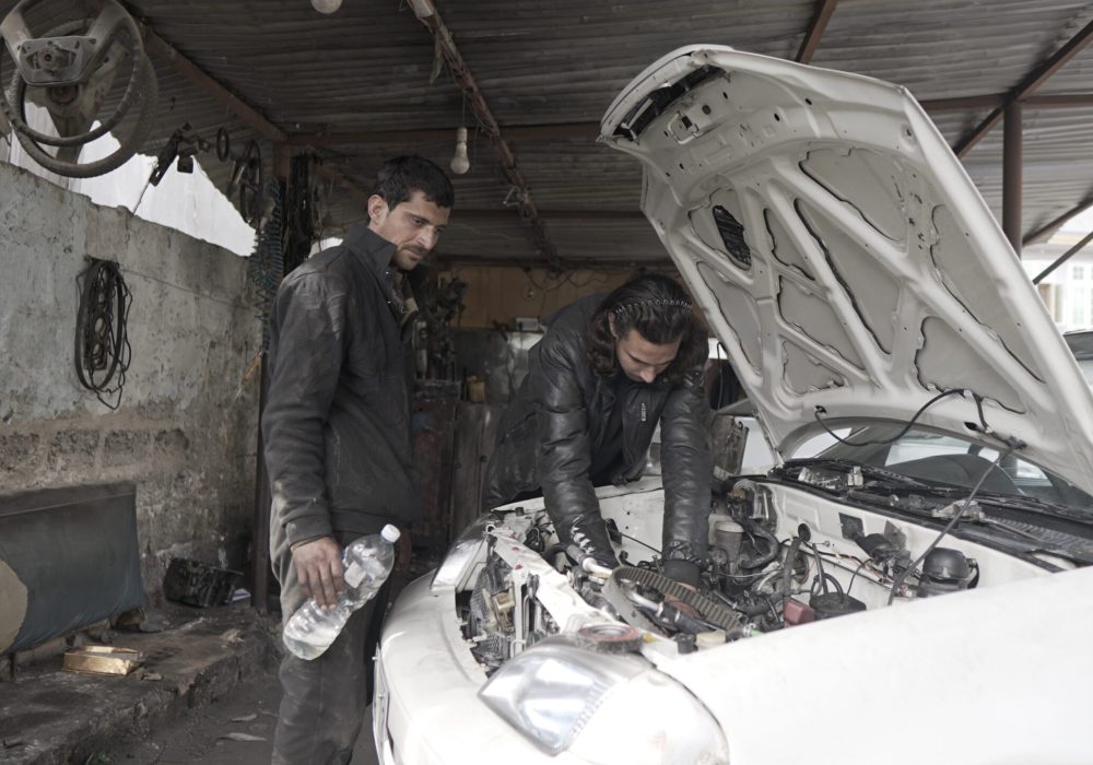 two mechanics working together