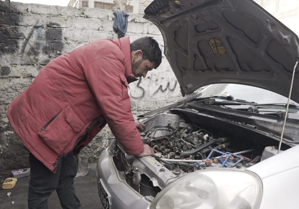 mechanic red jacket observing